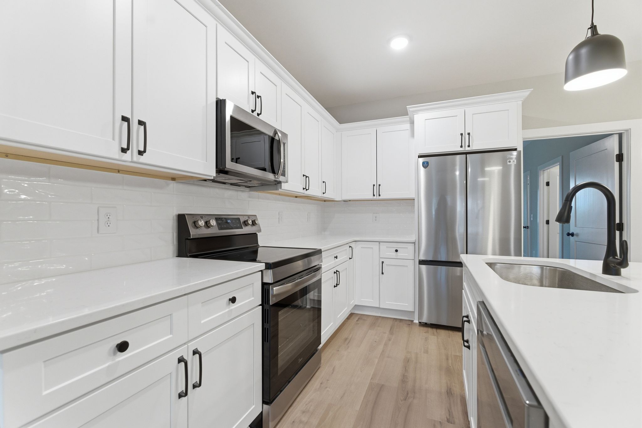 263 West Spring Street Smithville, TN 37166 - Photo 10 of 23 a kitchen with stainless steel appliances a refrigerator sink and white cabinets