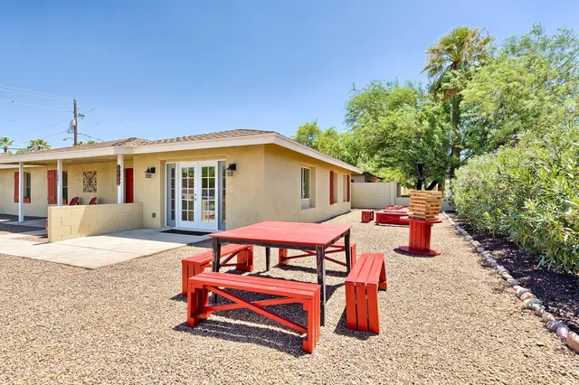 a view of a house with backyard and sitting area