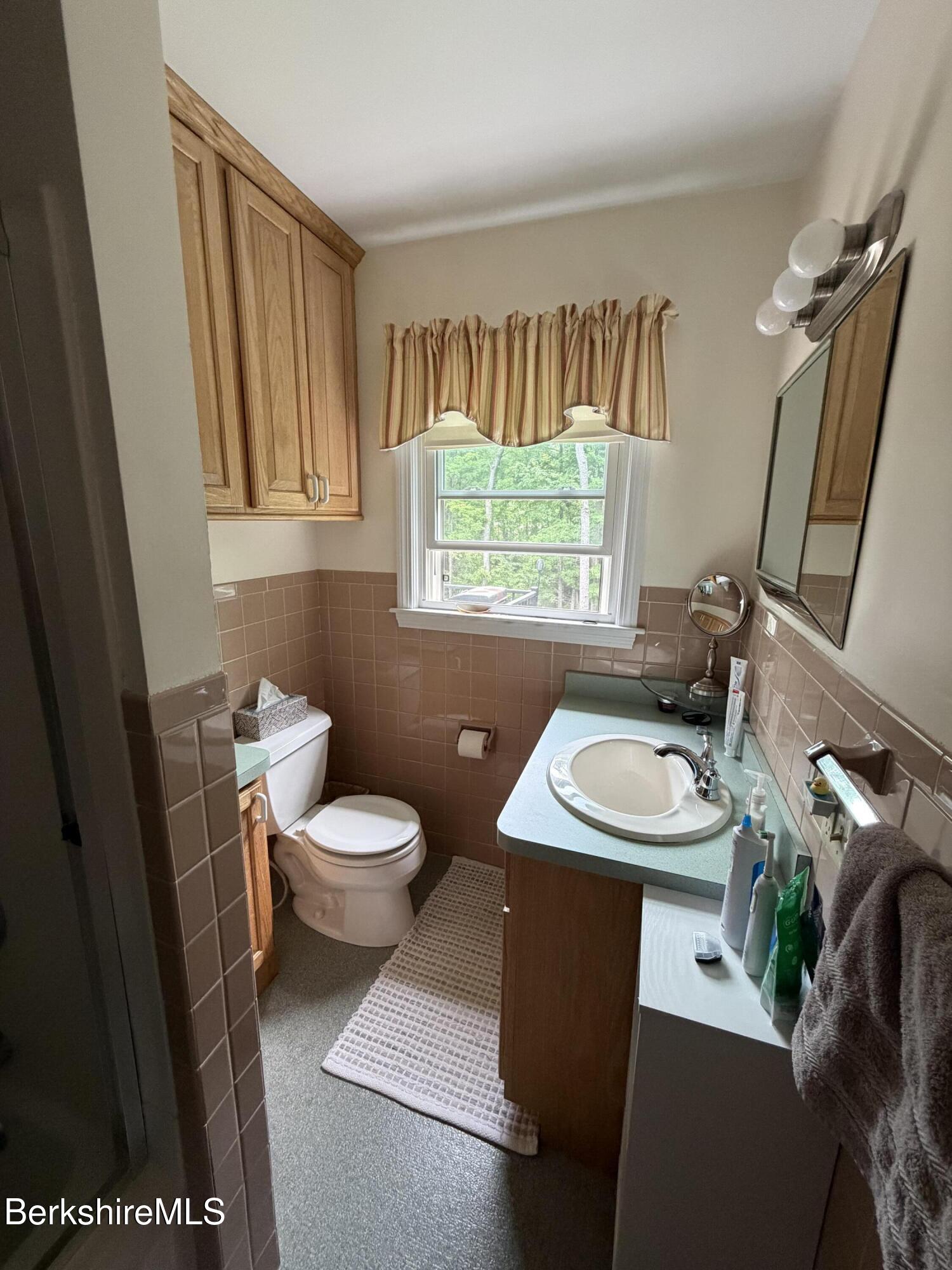 20 Sullivan Lane Lenox, MA 01240 - Photo 7 of 23 a bathroom with a sink a toilet and a mirror