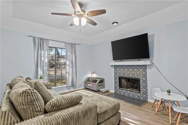 a living room with furniture a fireplace and a flat screen tv