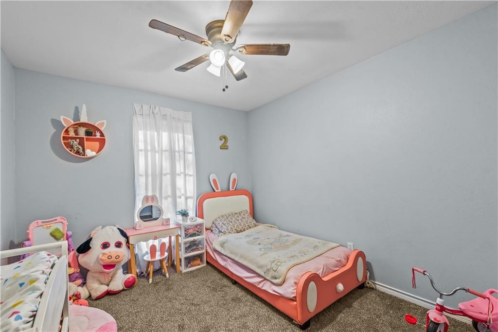 7302 Winding Star Drive Corpus Christi, TX 78413 - Photo 7 of 13 a bedroom with a bed and a chandelier