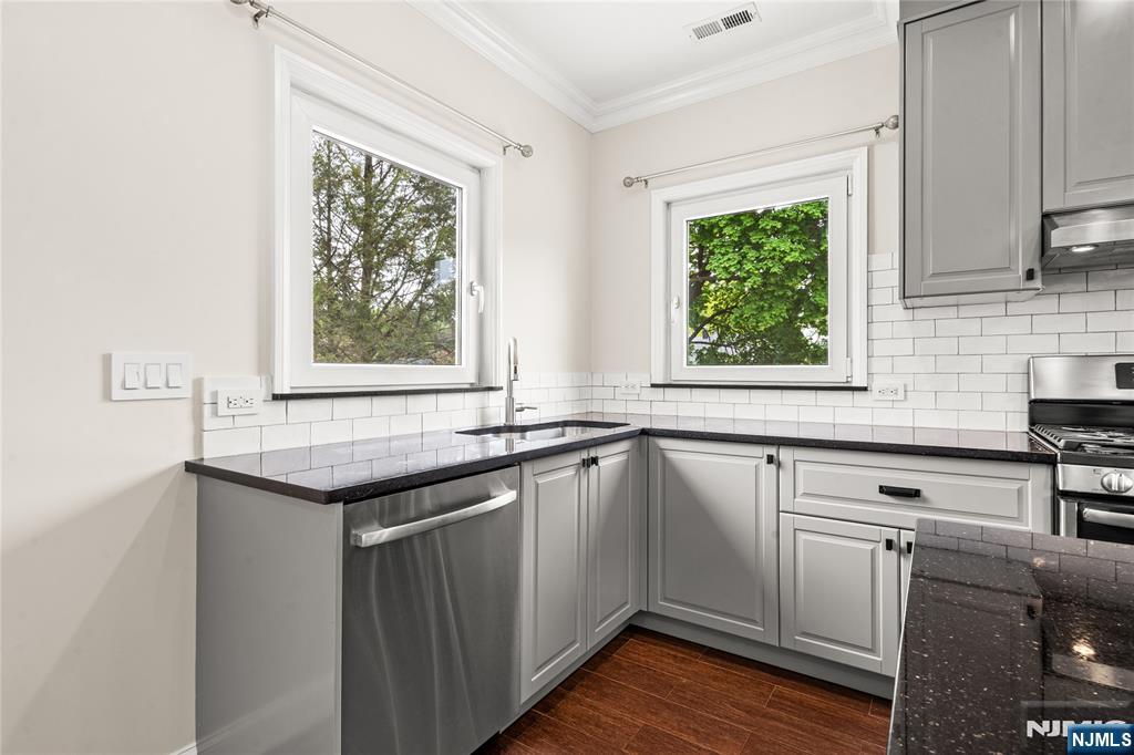 346 Cleveland Avenue, Unit 2 Hasbrouck Heights, NJ 07604 - Photo 14 of 39 a kitchen with a sink window and cabinets