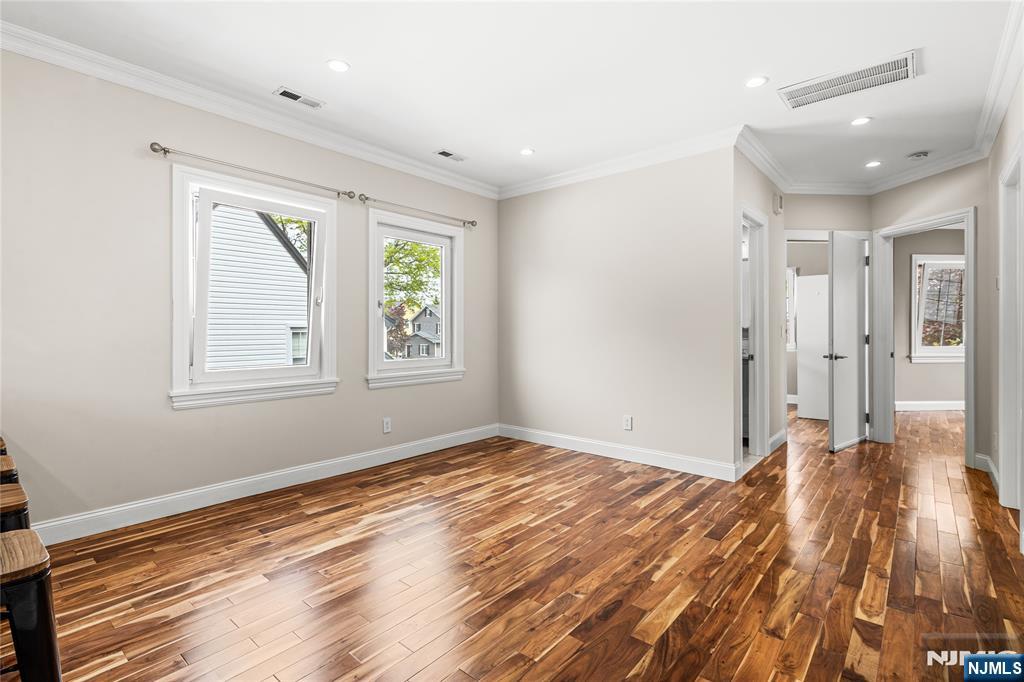 346 Cleveland Avenue, Unit 2 Hasbrouck Heights, NJ 07604 - Photo 21 of 39 a view of empty room with wooden floor and fan