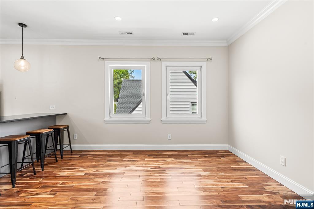 346 Cleveland Avenue, Unit 2 Hasbrouck Heights, NJ 07604 - Photo 22 of 39 a view of empty room with wooden floor and fan
