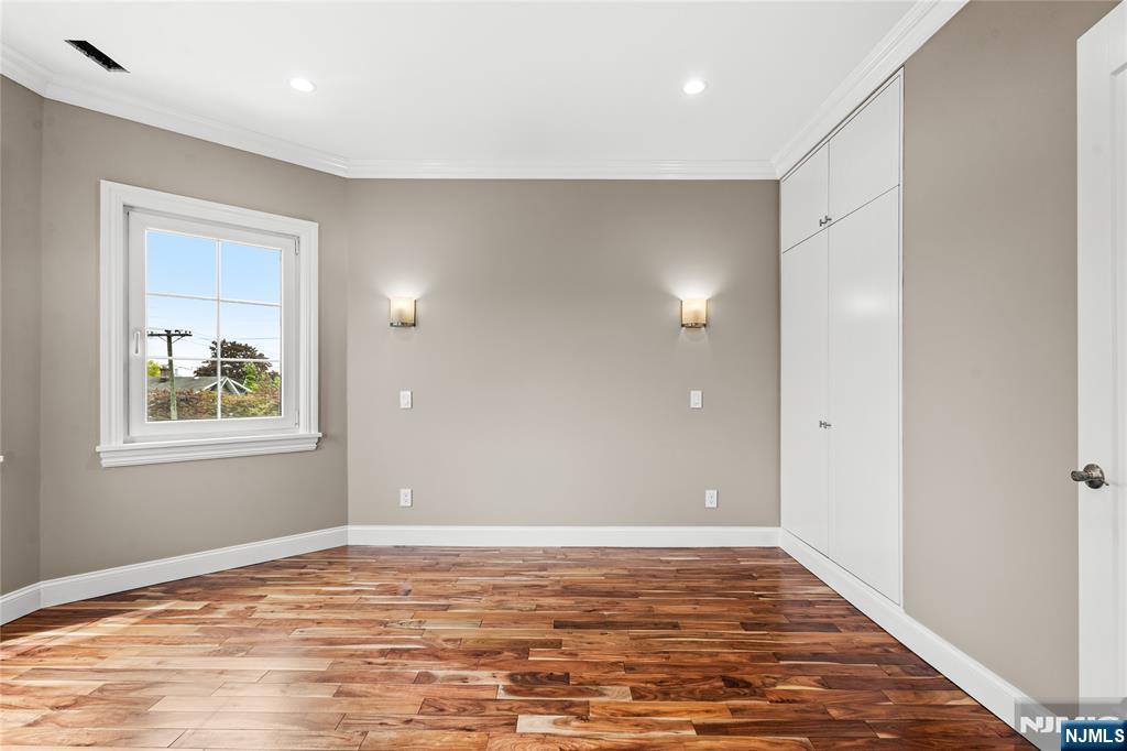346 Cleveland Avenue, Unit 2 Hasbrouck Heights, NJ 07604 - Photo 26 of 39 a view of an empty room with window and wooden floor