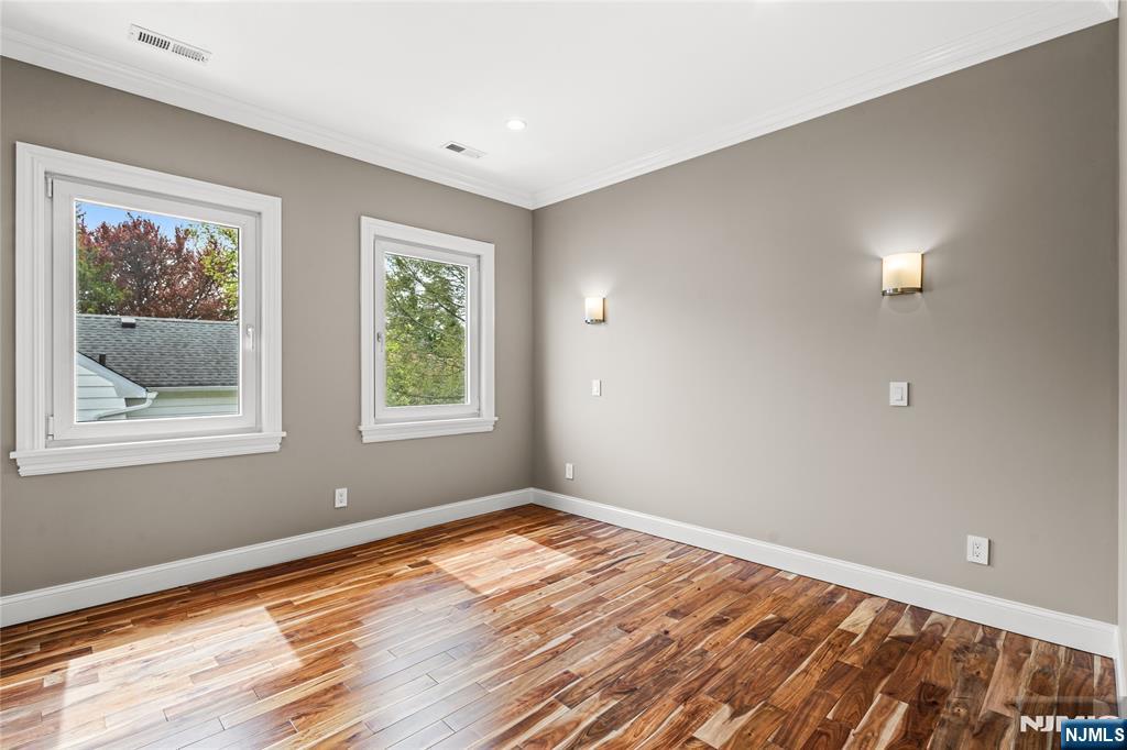 346 Cleveland Avenue, Unit 2 Hasbrouck Heights, NJ 07604 - Photo 28 of 39 a view of empty room with window and wooden floor