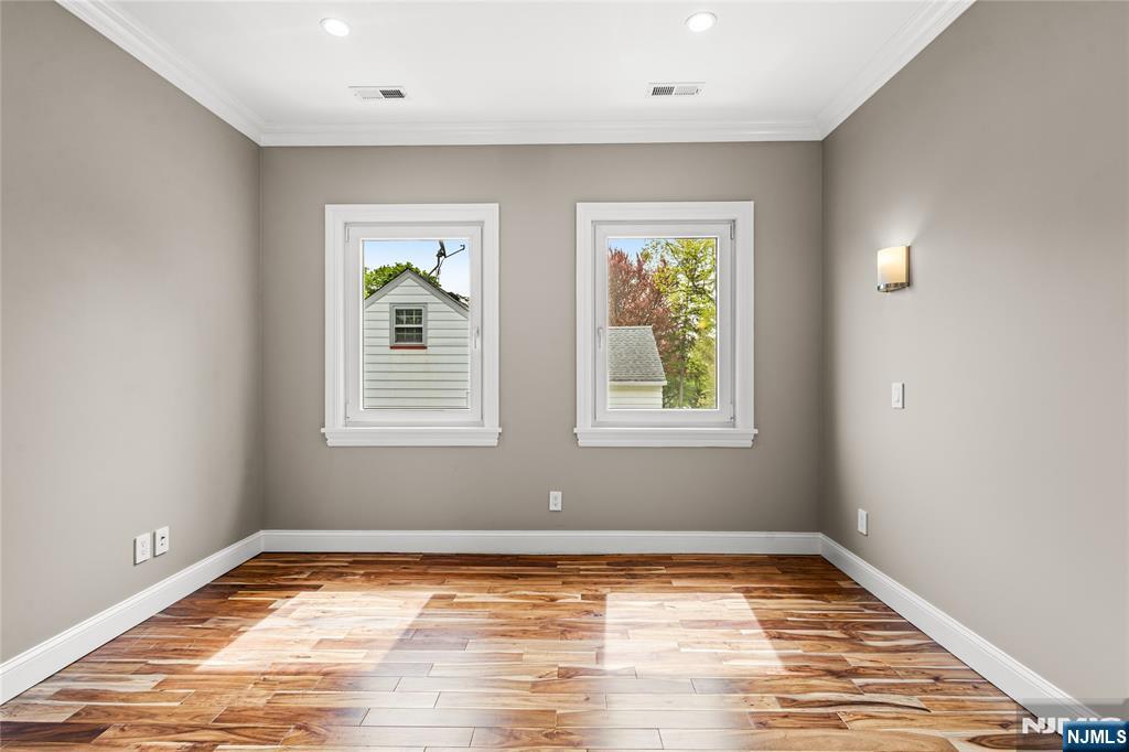 346 Cleveland Avenue, Unit 2 Hasbrouck Heights, NJ 07604 - Photo 29 of 39 a view of a room with wooden floor and windows