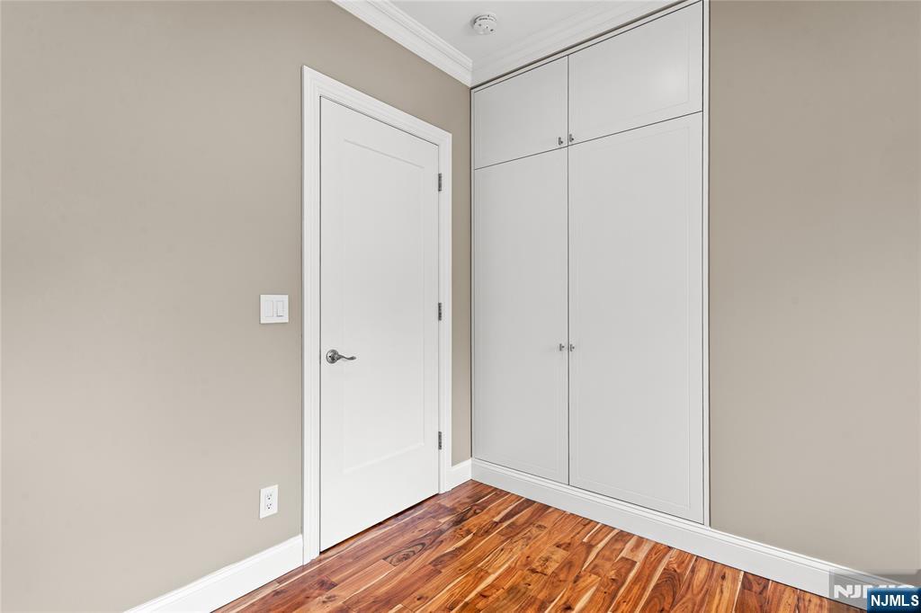 346 Cleveland Avenue, Unit 2 Hasbrouck Heights, NJ 07604 - Photo 30 of 39 a view of an empty room with wooden floor