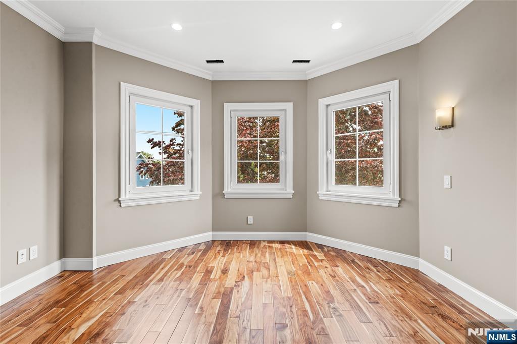 346 Cleveland Avenue, Unit 2 Hasbrouck Heights, NJ 07604 - Photo 31 of 39 a view of empty room with wooden floor and fan