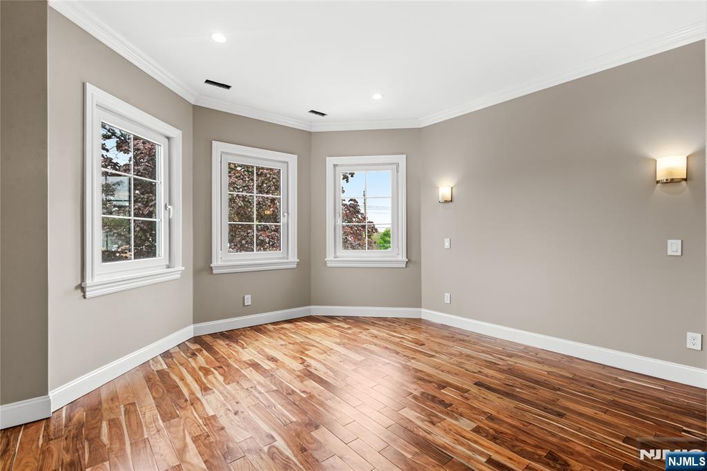 346 Cleveland Avenue, Unit 2 Hasbrouck Heights, NJ 07604 - Photo 32 of 39 a view of empty room with wooden floor and fan
