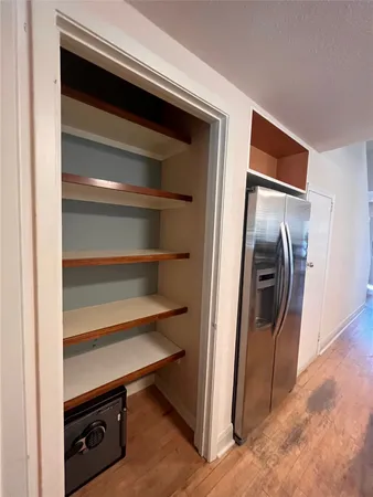 a view of walk in closet with empty racks