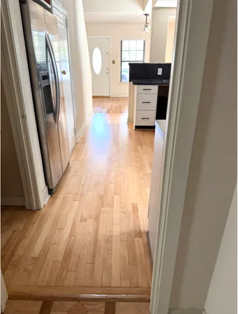 a view of a kitchen from a hallway