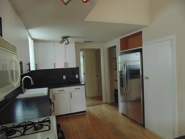 a kitchen with a sink and a refrigerator