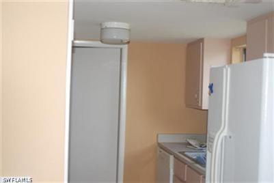 2244 Lotus Road Fort Myers, FL 33905 - Photo 5 of 6 a kitchen with a refrigerator and a stove