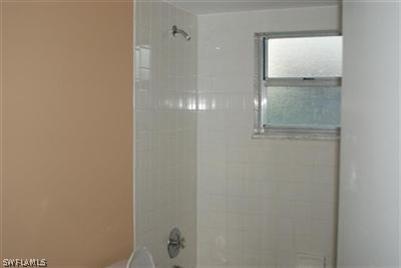 2244 Lotus Road Fort Myers, FL 33905 - Photo 6 of 6 a bathroom with a glass shower door