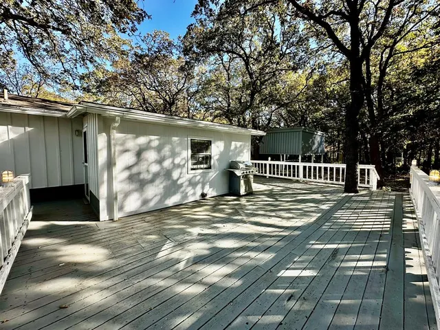 a view of a deck with a white fence
