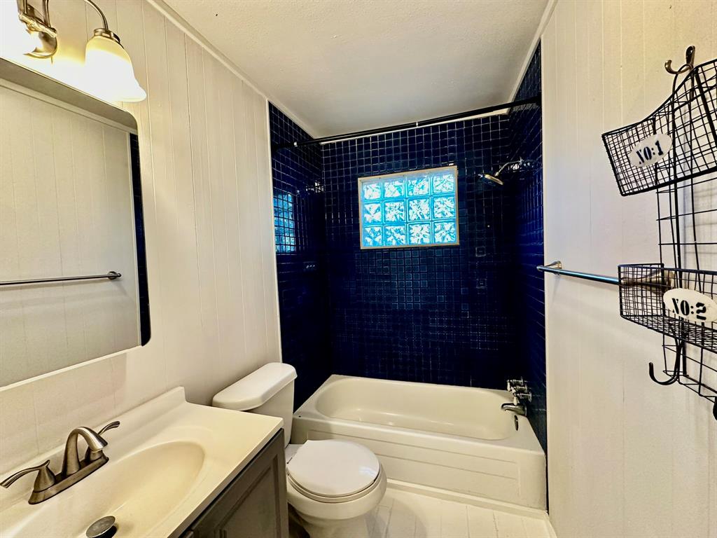 318 Windsor Drive Pottsboro, TX 75076 - Photo 13 of 18 a bathroom with a sink toilet and shower