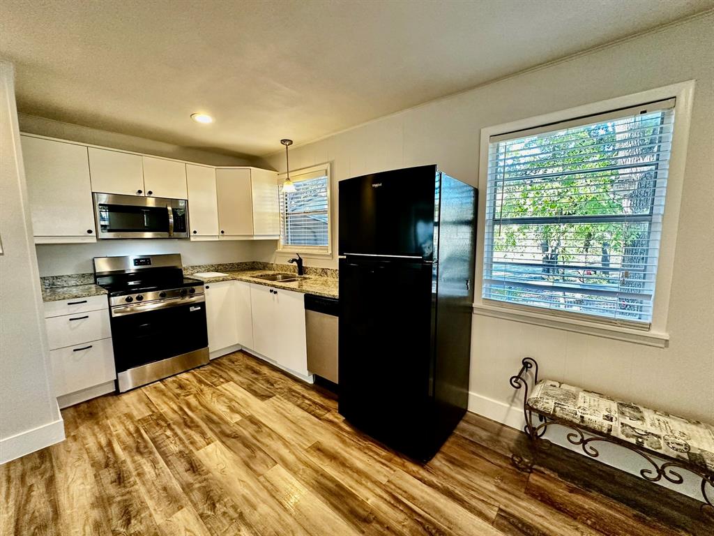 318 Windsor Drive Pottsboro, TX 75076 - Photo 2 of 18 a kitchen with a refrigerator and a stove top oven
