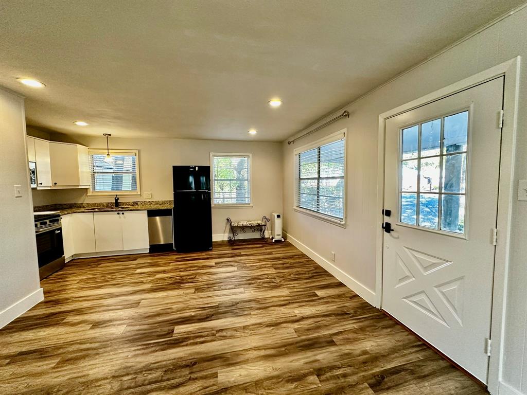 318 Windsor Drive Pottsboro, TX 75076 - Photo 8 of 18 a view of a kitchen with kitchen island a stove a refrigerator cabinets and a large window