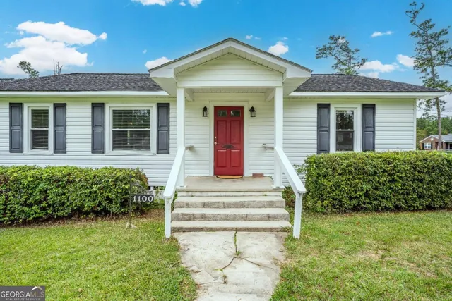 a front view of a house with a yard