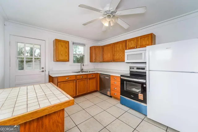 a kitchen with stainless steel appliances a refrigerator sink and microwave