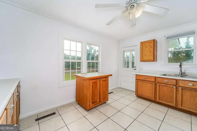 an empty room with a window and a fan