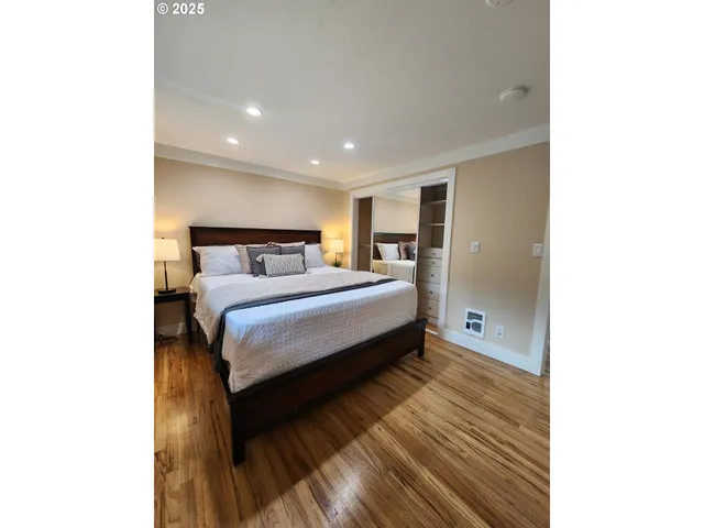 a bedroom with a bed and a mirror