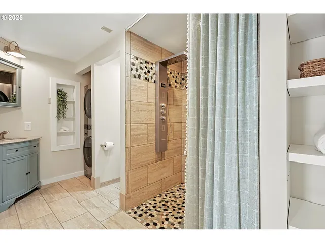 a bathroom with a shower and a sink