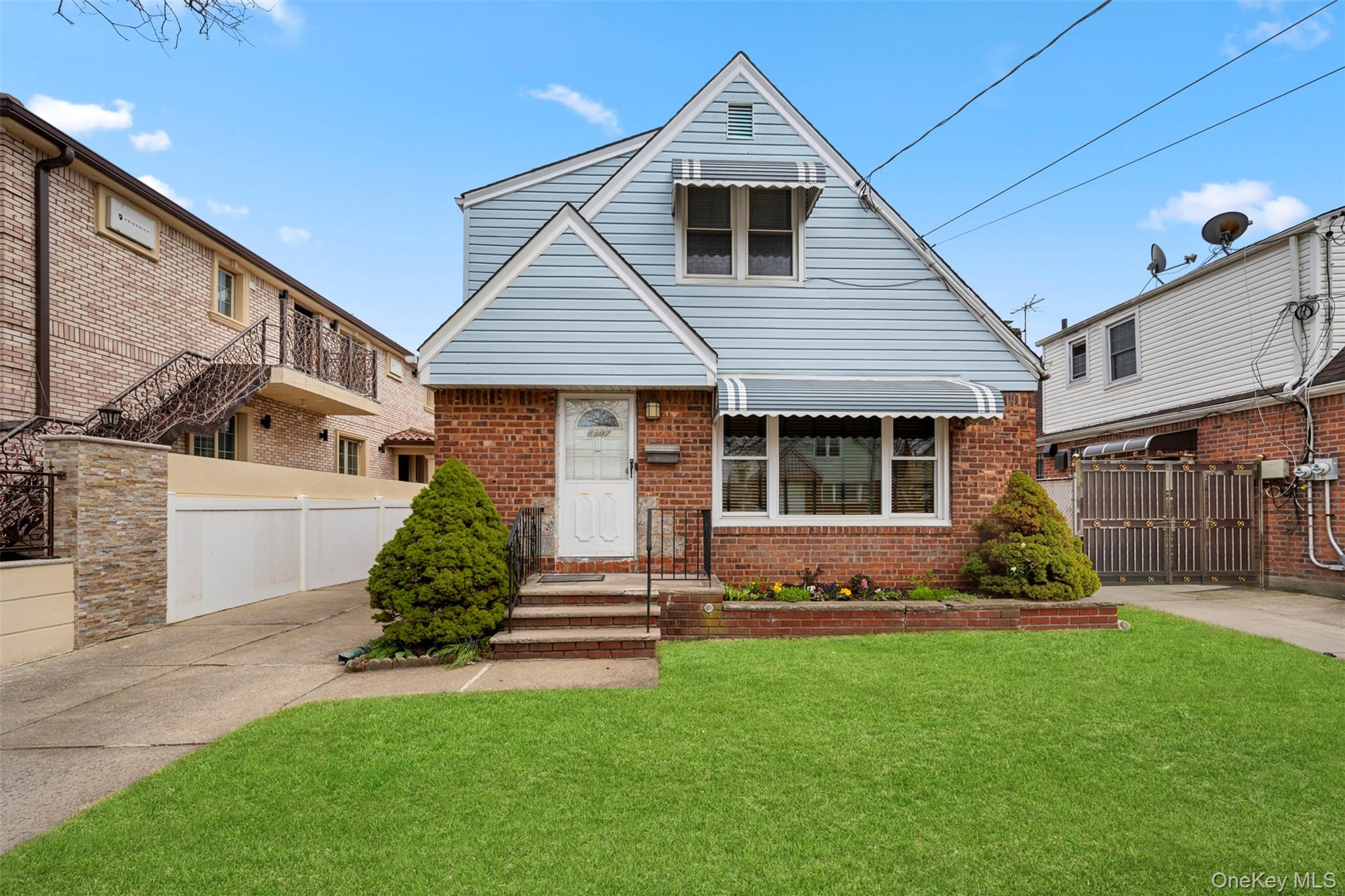 8807 Sabre Street Queens, NY 11427 - Photo 1 of 29 a front view of a house with a yard