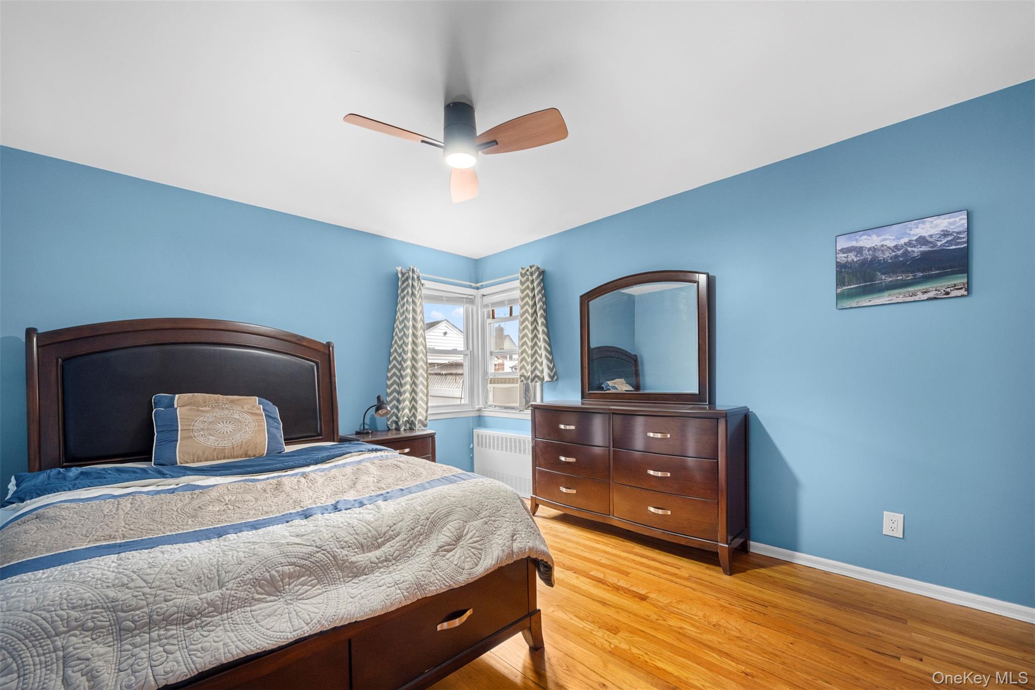 8807 Sabre Street Queens, NY 11427 - Photo 11 of 29 a bedroom with a bed and a dresser