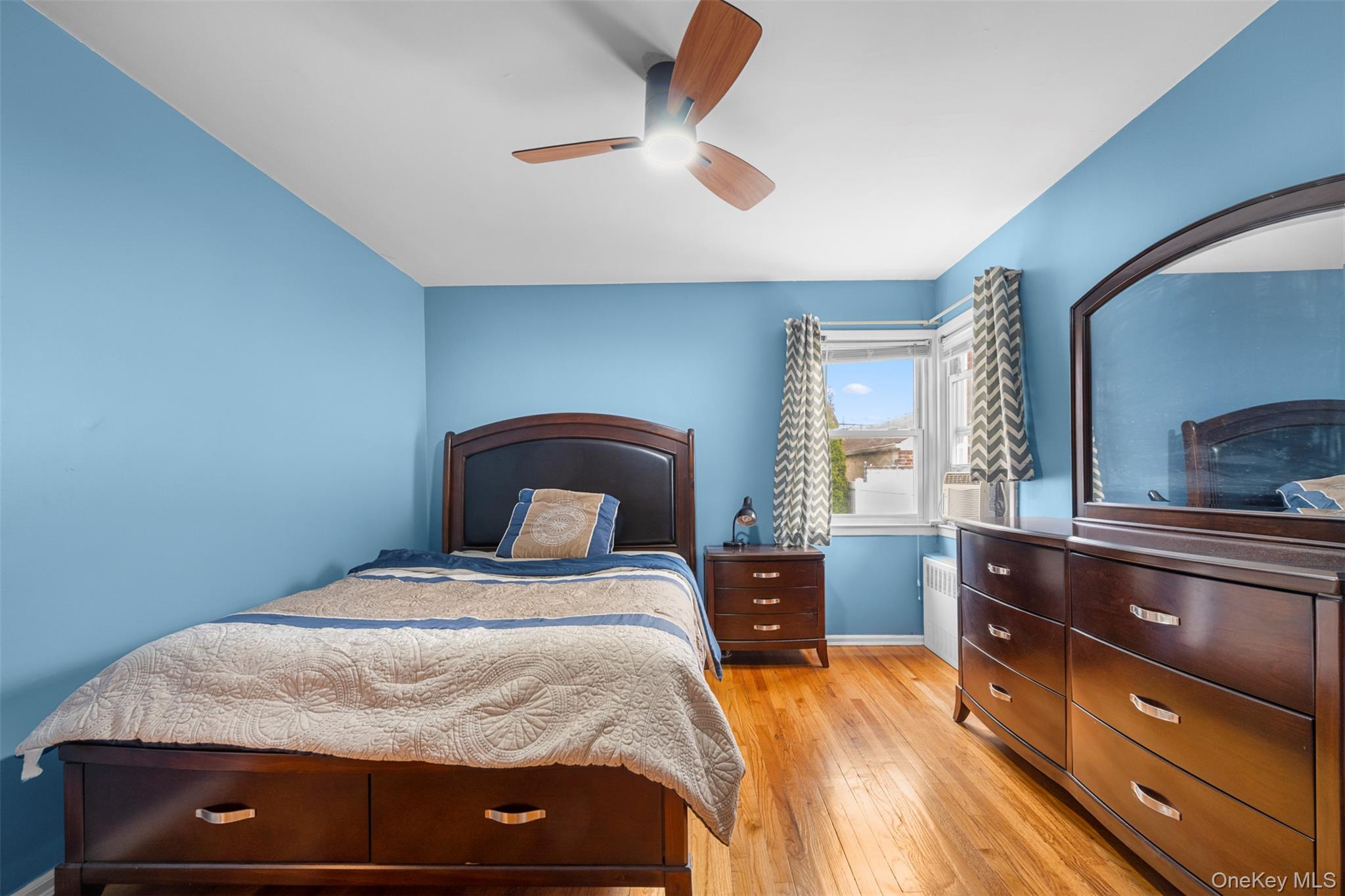 8807 Sabre Street Queens, NY 11427 - Photo 12 of 29 a bedroom with a bed and a dresser