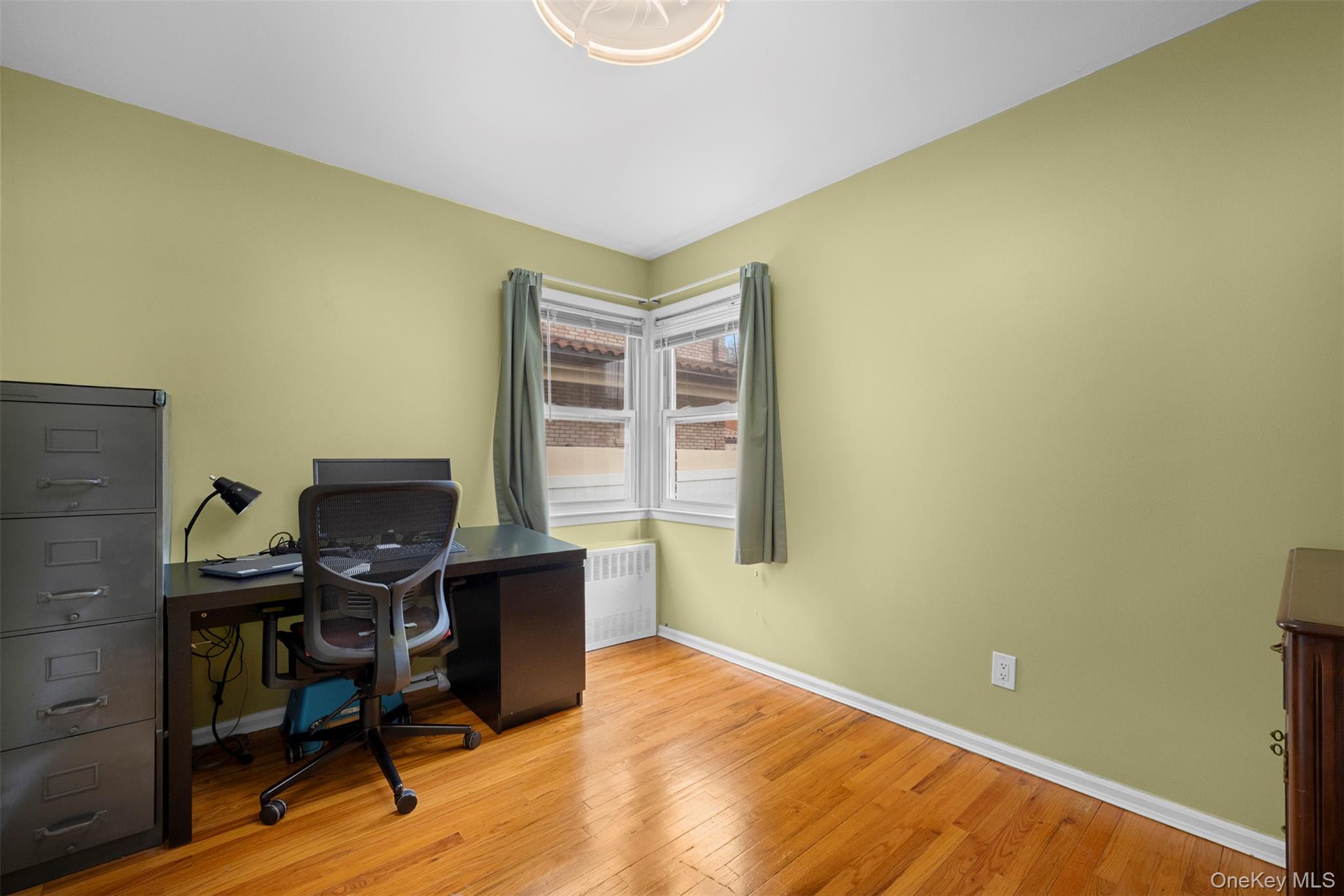 8807 Sabre Street Queens, NY 11427 - Photo 13 of 29 a view of a workspace with furniture and wooden floor