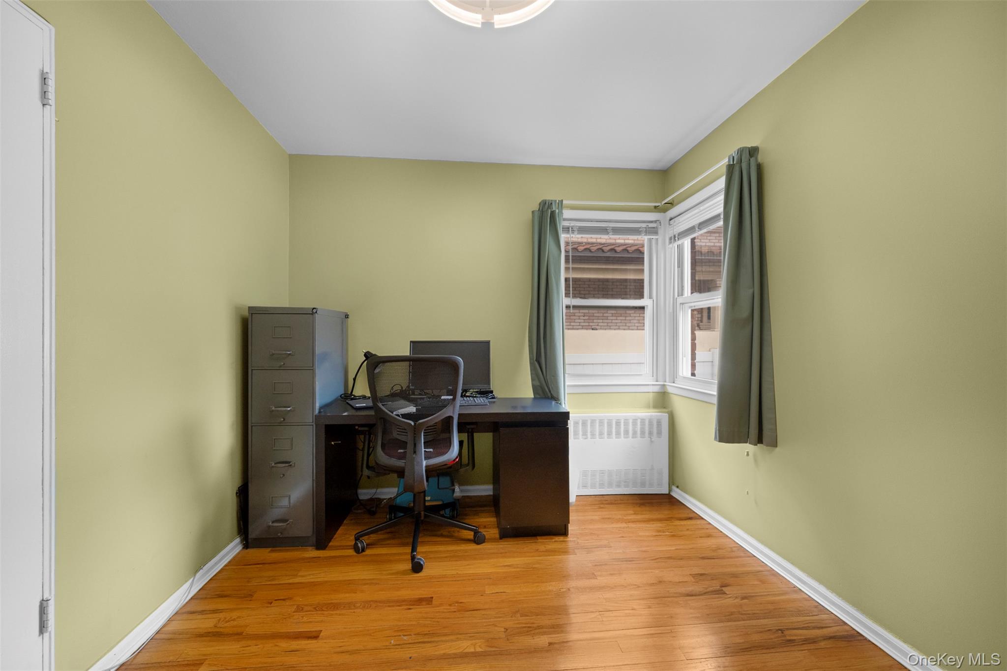 8807 Sabre Street Queens, NY 11427 - Photo 14 of 29 a view of a workspace with furniture and wooden floor