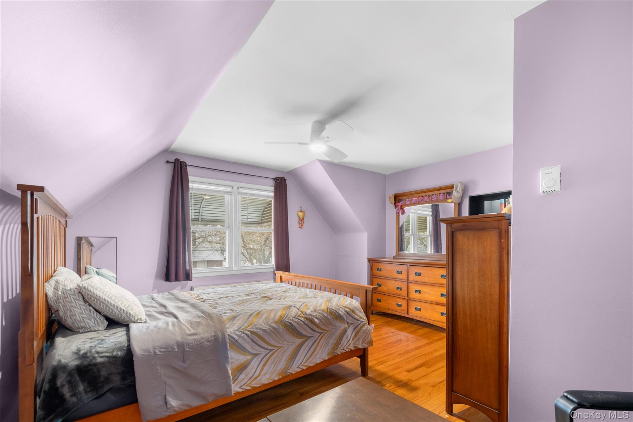 8807 Sabre Street Queens, NY 11427 - Photo 17 of 29 a bedroom with a bed and wooden floor