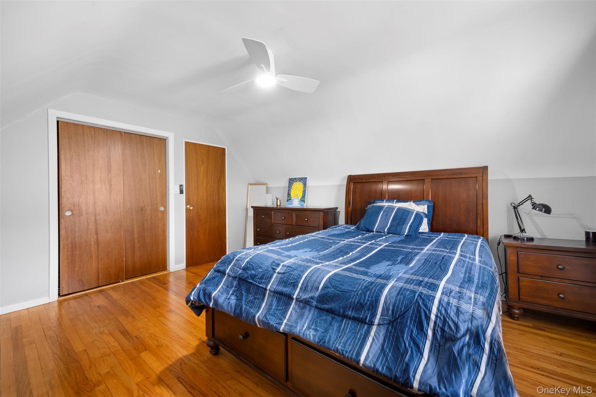 8807 Sabre Street Queens, NY 11427 - Photo 19 of 29 a bedroom with a bed and dresser