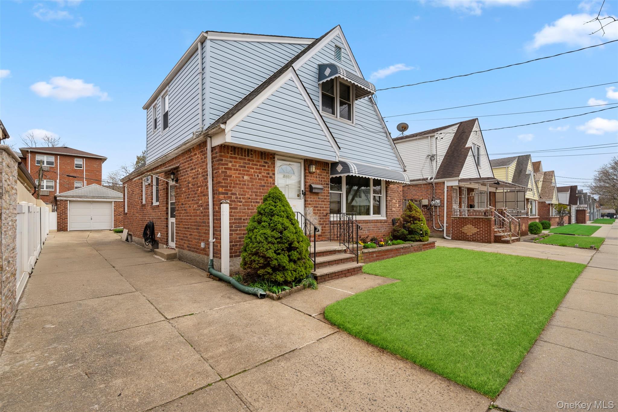 8807 Sabre Street Queens, NY 11427 - Photo 2 of 29 a front view of a house with a garden and plants