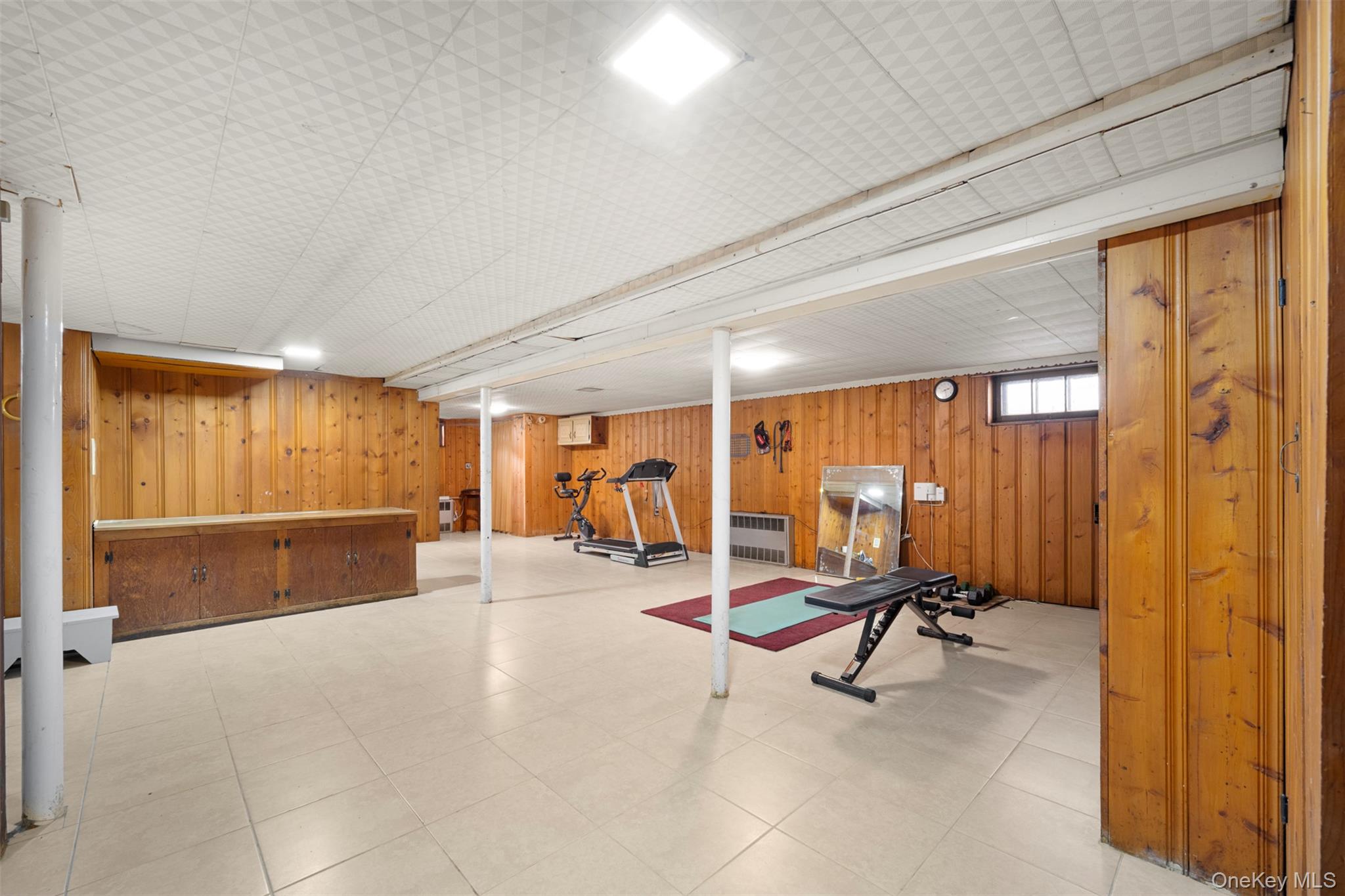 8807 Sabre Street Queens, NY 11427 - Photo 21 of 29 a view of a room with gym equipment and a large window