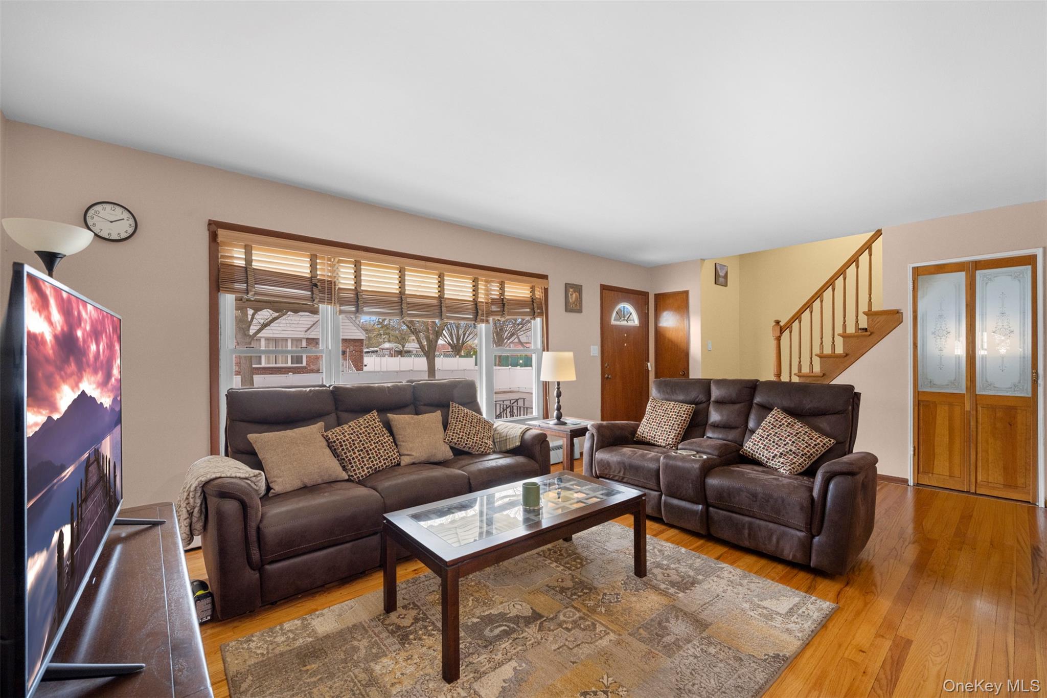 8807 Sabre Street Queens, NY 11427 - Photo 5 of 29 a living room with furniture and a flat screen tv
