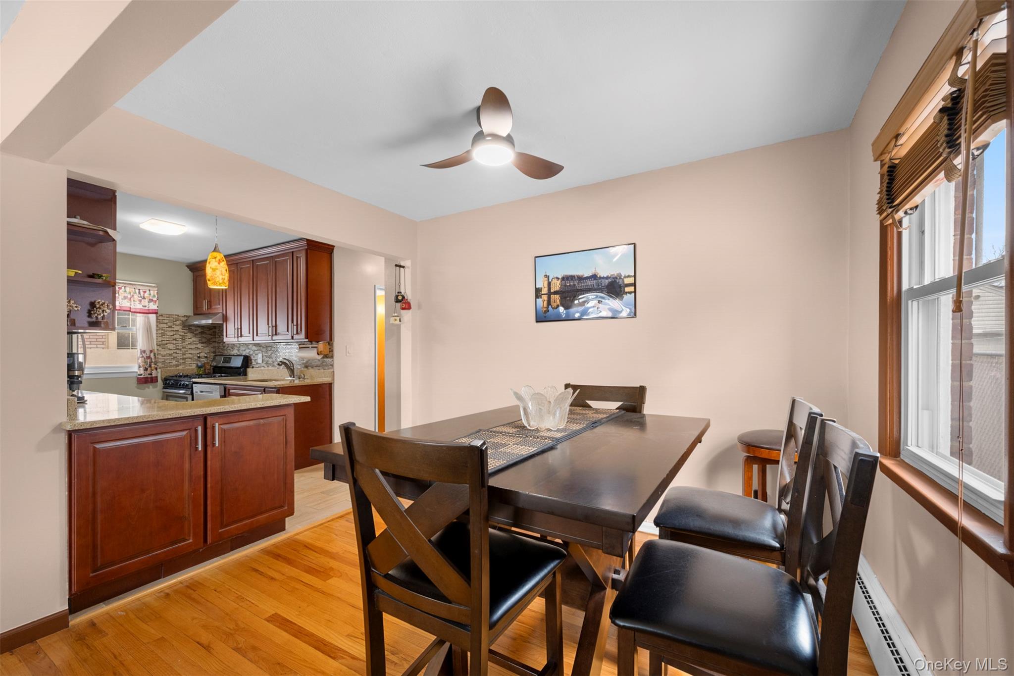 8807 Sabre Street Queens, NY 11427 - Photo 6 of 29 a view of a dining room with furniture a kitchen and chandelier
