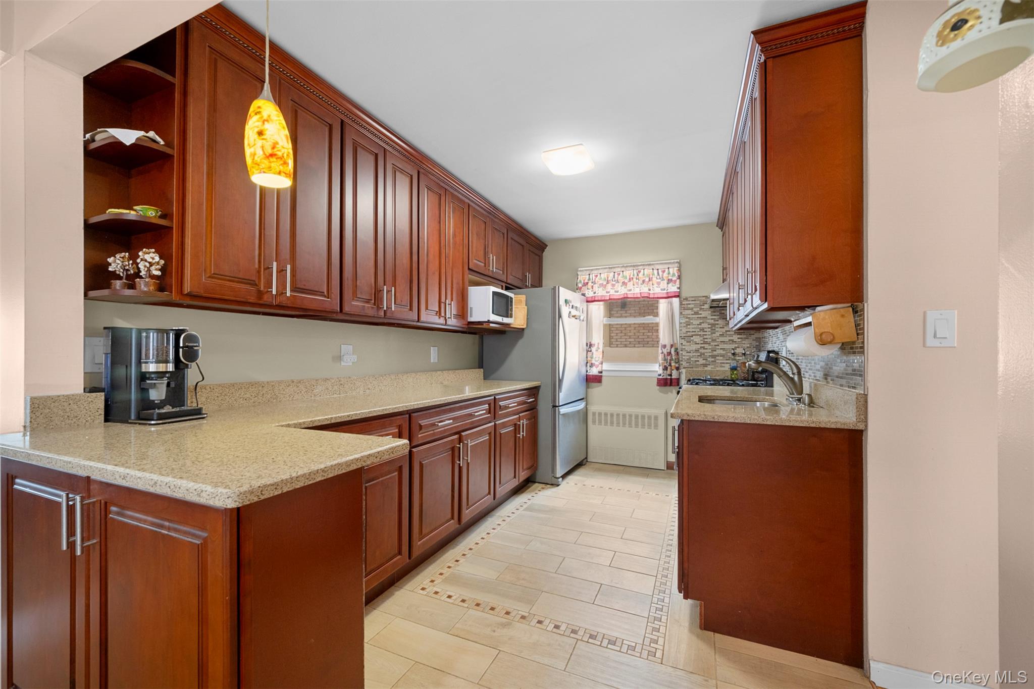 8807 Sabre Street Queens, NY 11427 - Photo 7 of 29 a kitchen with stainless steel appliances granite countertop a sink stove and cabinets