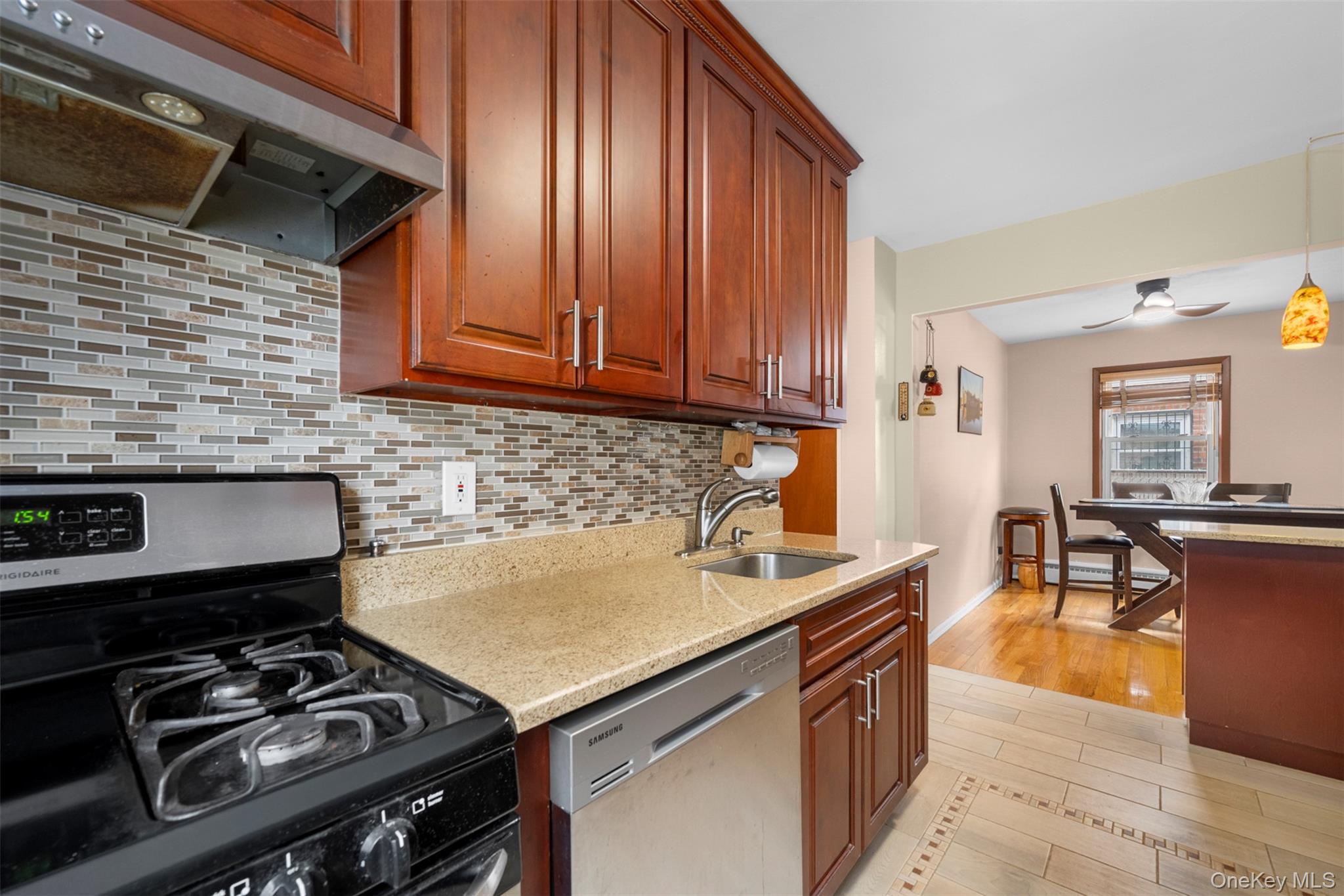 8807 Sabre Street Queens, NY 11427 - Photo 10 of 29 a kitchen with a stove and a sink
