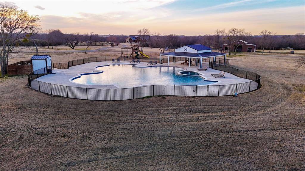 5165 Hartlee Field Road Denton, TX 76208 - Photo 12 of 39 a view of a swimming pool and lounge chair