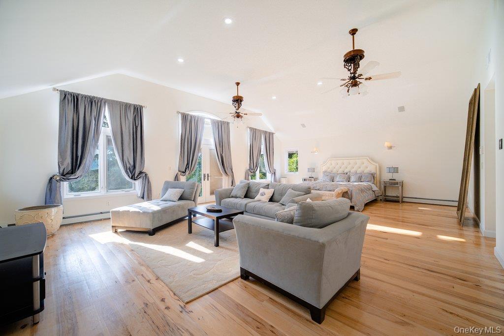 237 Mineral Springs Road Highland Mills, NY 10930 - Photo 22 of 32 Living room featuring vaulted ceiling, light wood-type flooring, recessed lighting, ceiling fan, and a baseboard radiator