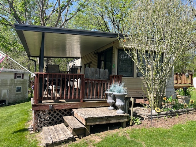 a view of house with backyard outdoor seating and hardwood