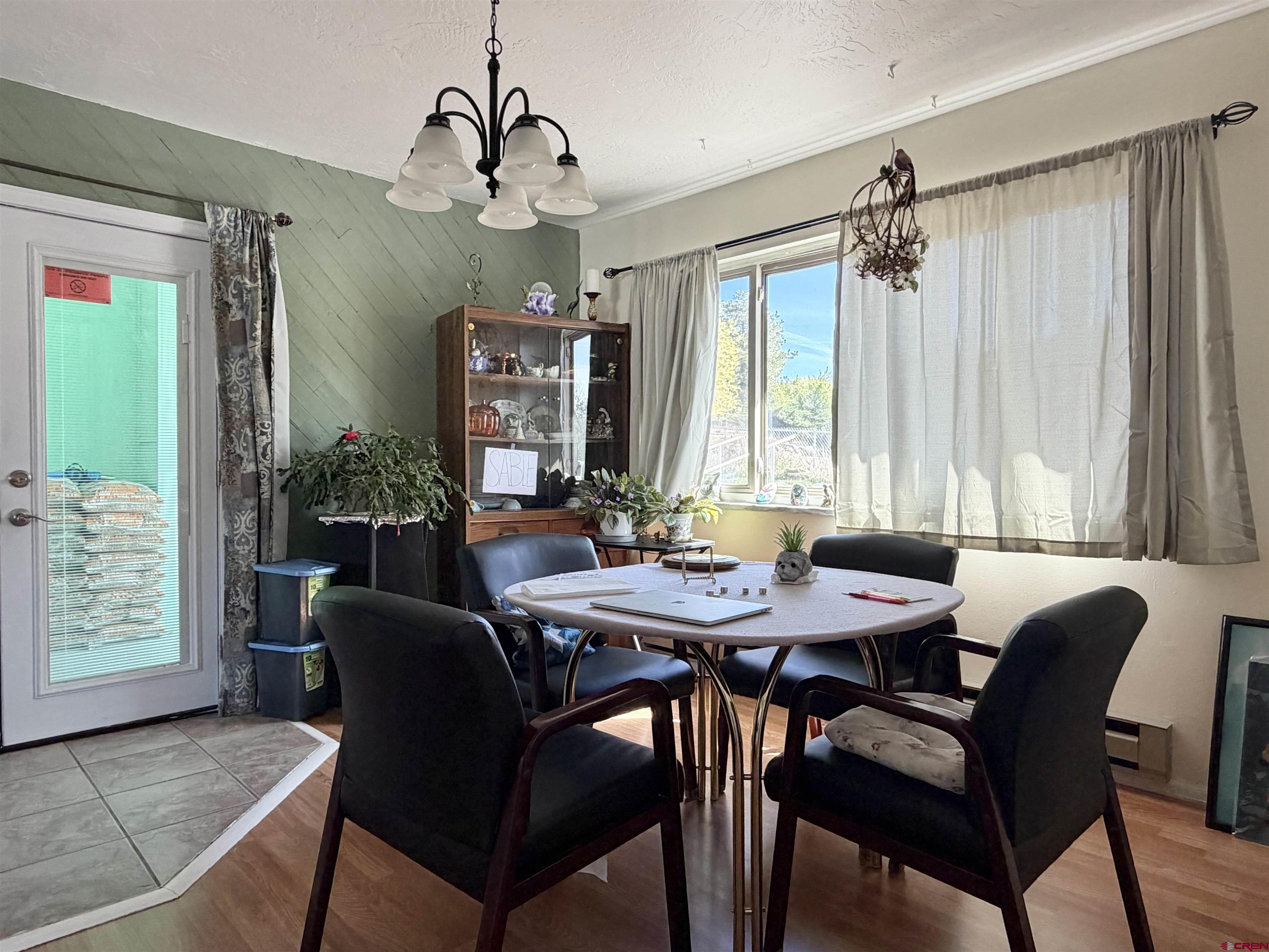 265 Northwest 10th Street Cedaredge, CO 81413 - Photo 13 of 40 a view of a a dining room with furniture window and wooden floor