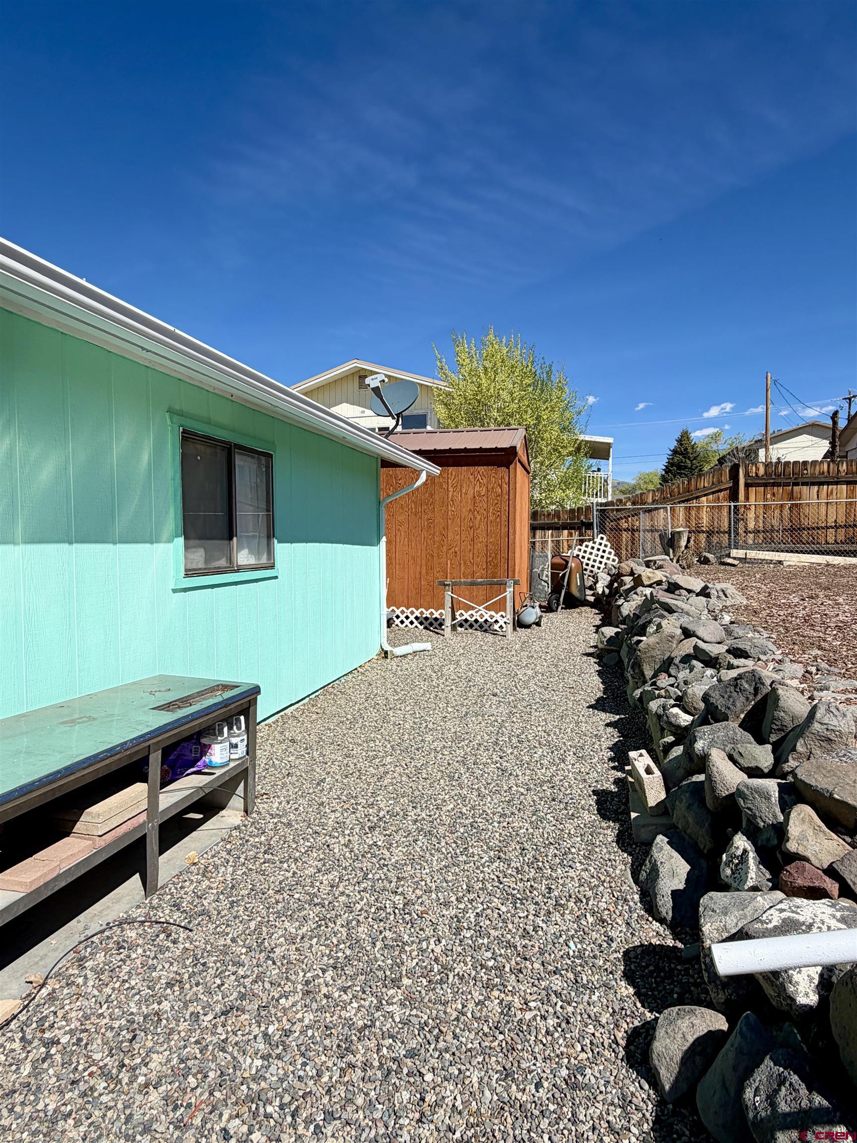 265 Northwest 10th Street Cedaredge, CO 81413 - Photo 32 of 40 a backyard of a house with table and chairs