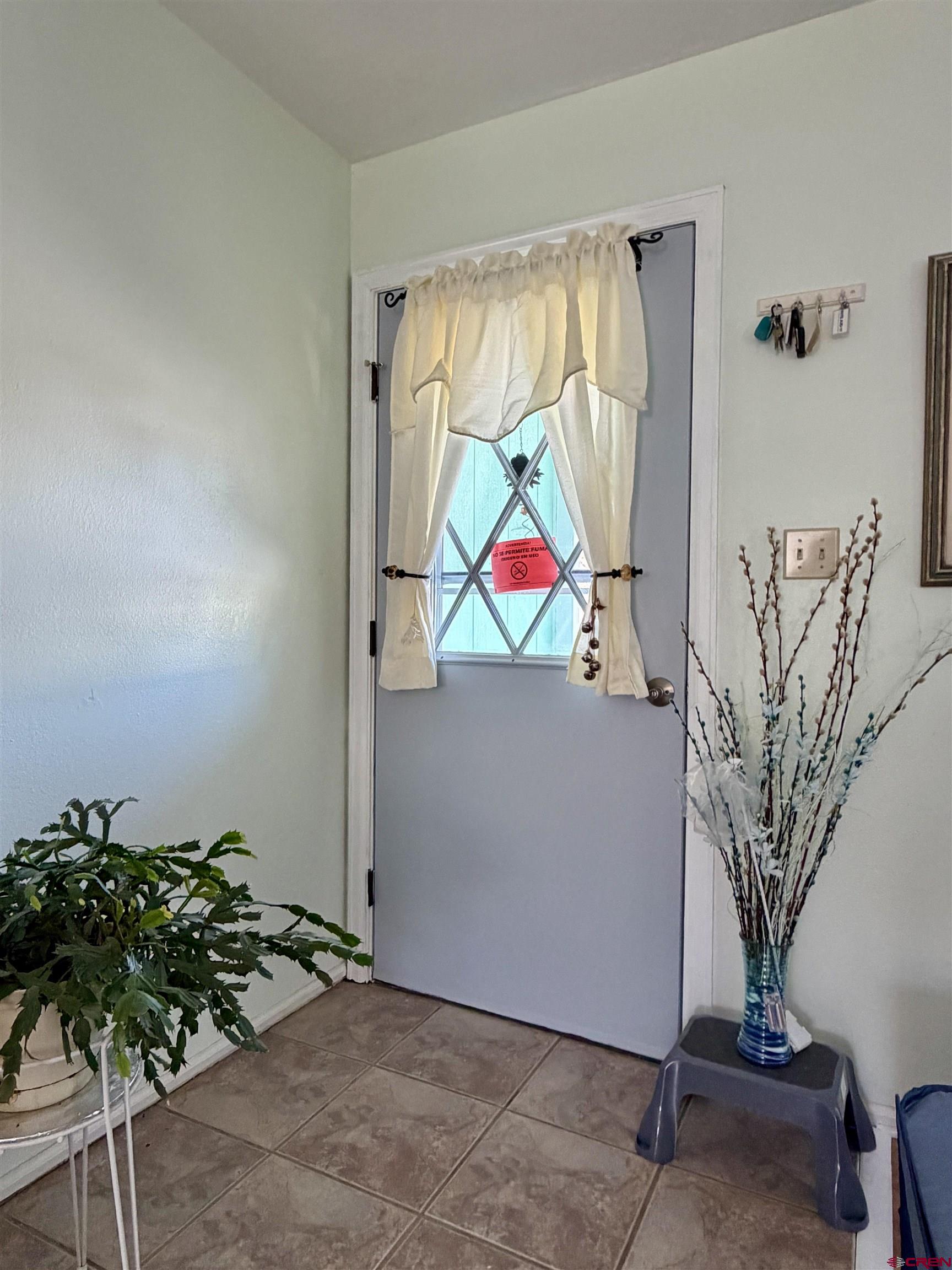 265 Northwest 10th Street Cedaredge, CO 81413 - Photo 5 of 40 a room with a potted plant and a large window