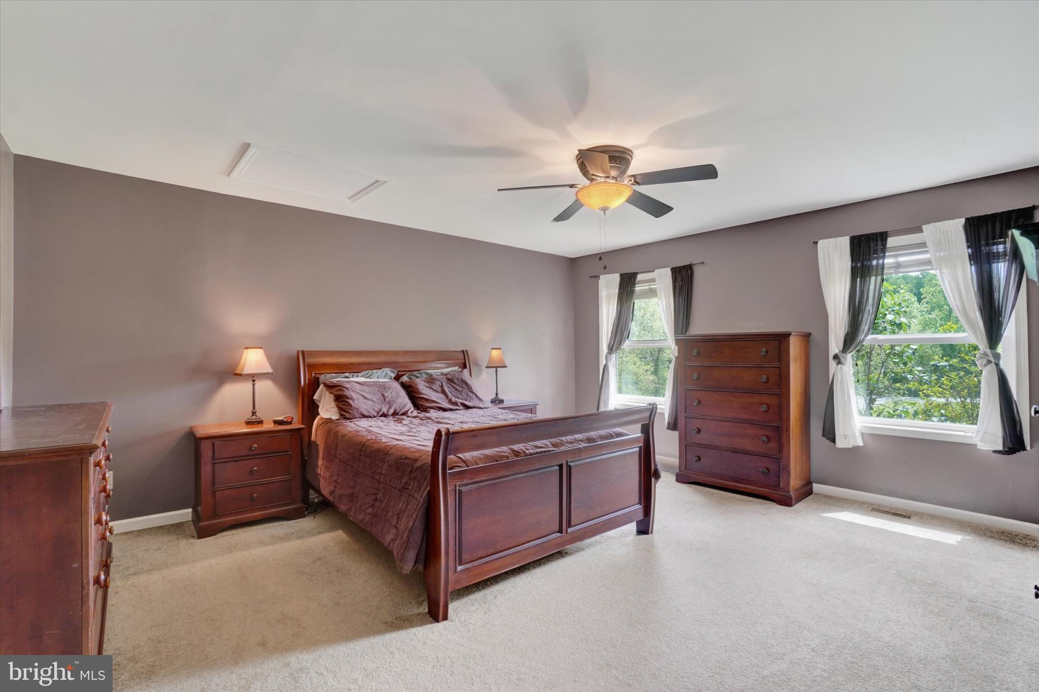 1055 Copenhaffer Road York, PA 17404 - Photo 23 of 38 a spacious bedroom with a bed and a chandelier