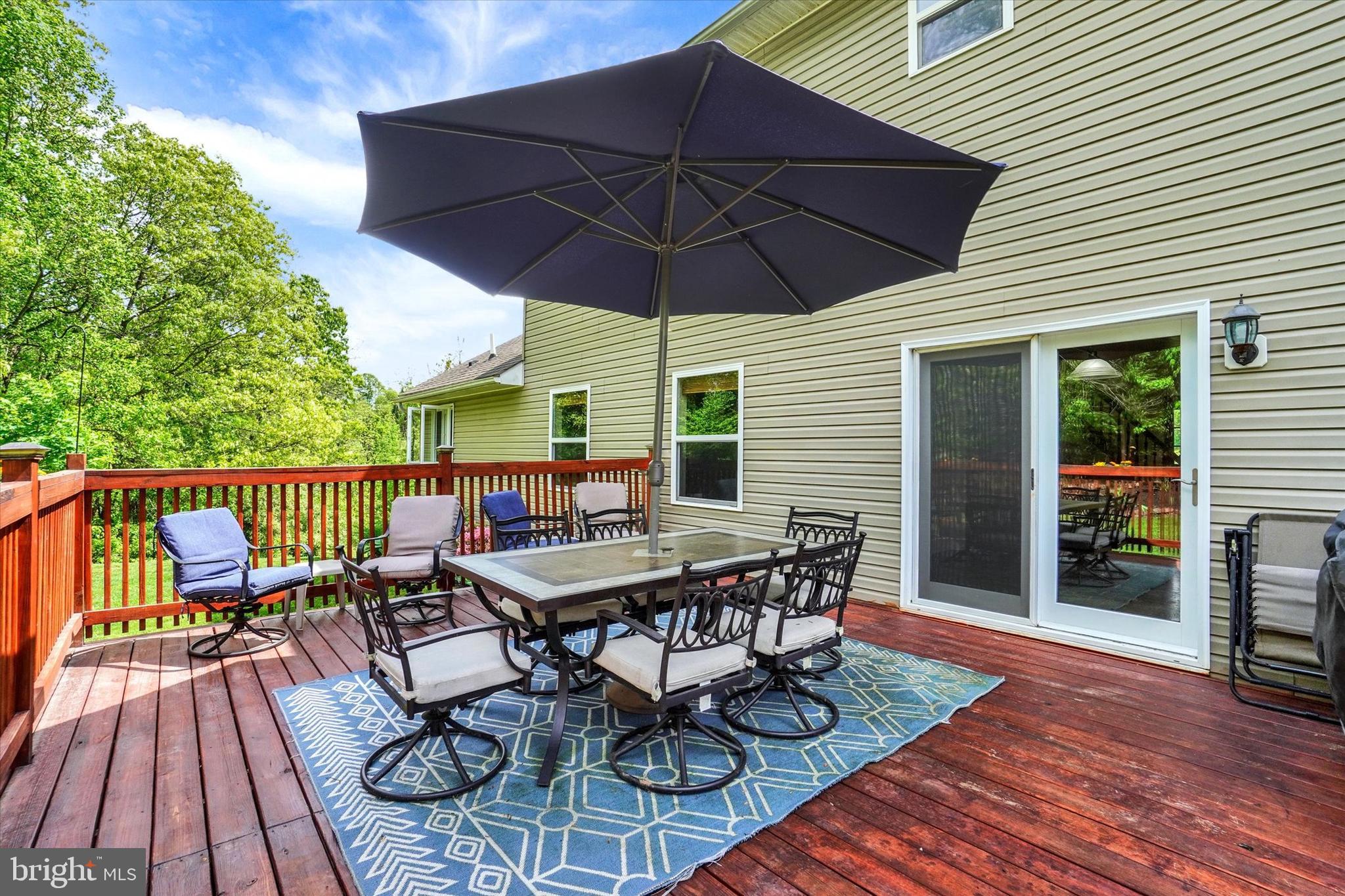 1055 Copenhaffer Road York, PA 17404 - Photo 30 of 38 a patio with wooden floor a yard a table and chairs