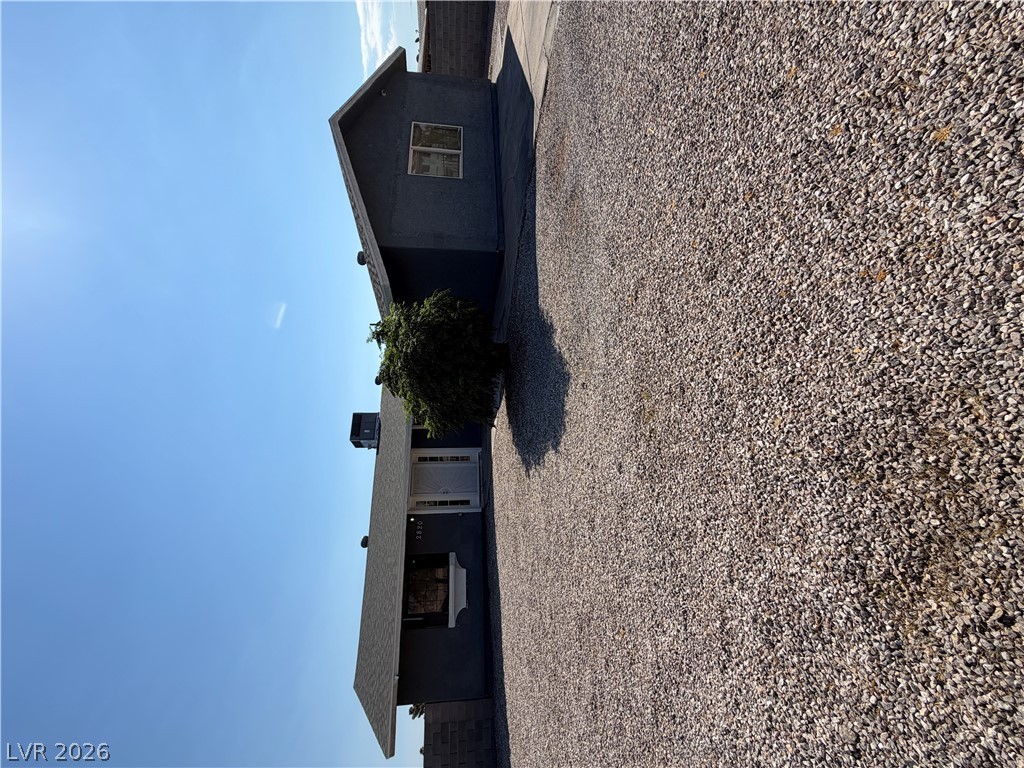 2820 South Sandhill Road, Unit A Las Vegas, NV 89121 - Photo 2 of 26 A dark-toned single-story residence with a gravel driveway and minimal landscaping.